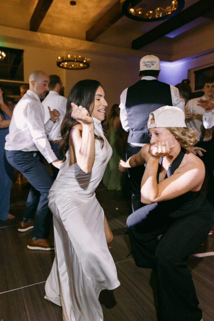 Bride dancing with friends on a packed dance floor at TPC Colorado