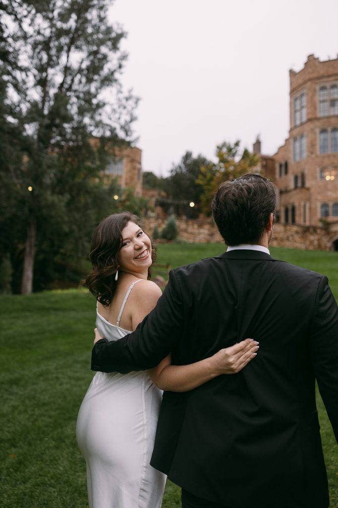 Bridgette glances back over her shoulder as the couple walks arm in arm