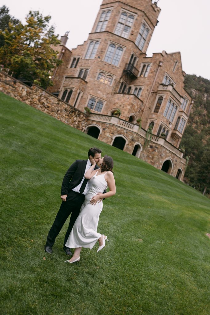 Logan kisses Bridgette's cheek as she pops her foot on the castle lawn