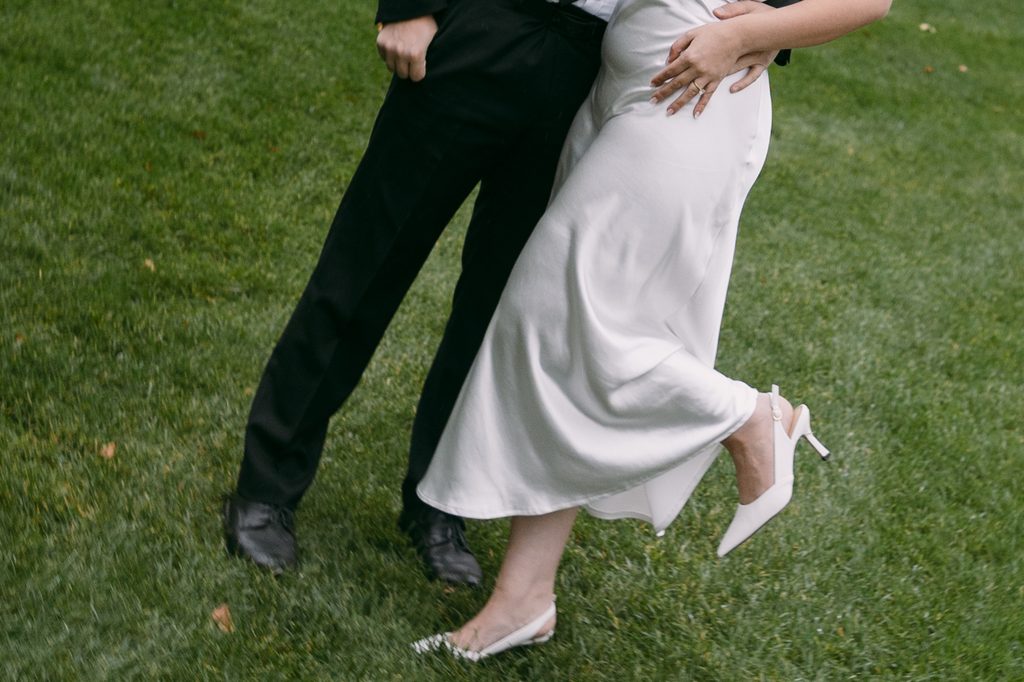 Close-up of Bridgette's heel kicking up as the couple dances on the grass