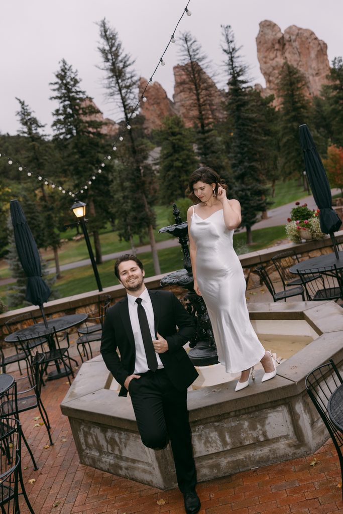 Bridgette poses on the fountain ledge as Logan leans against it on the Glen Eyrie Castle patio